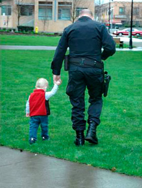 Policeman Holding Boy's Hand