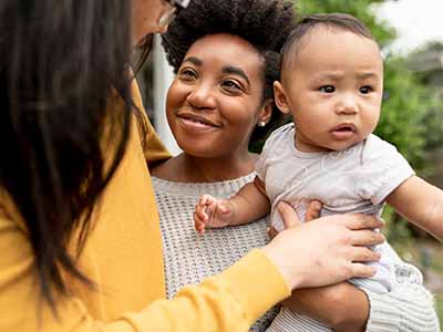 Young mixed race man and women with infant