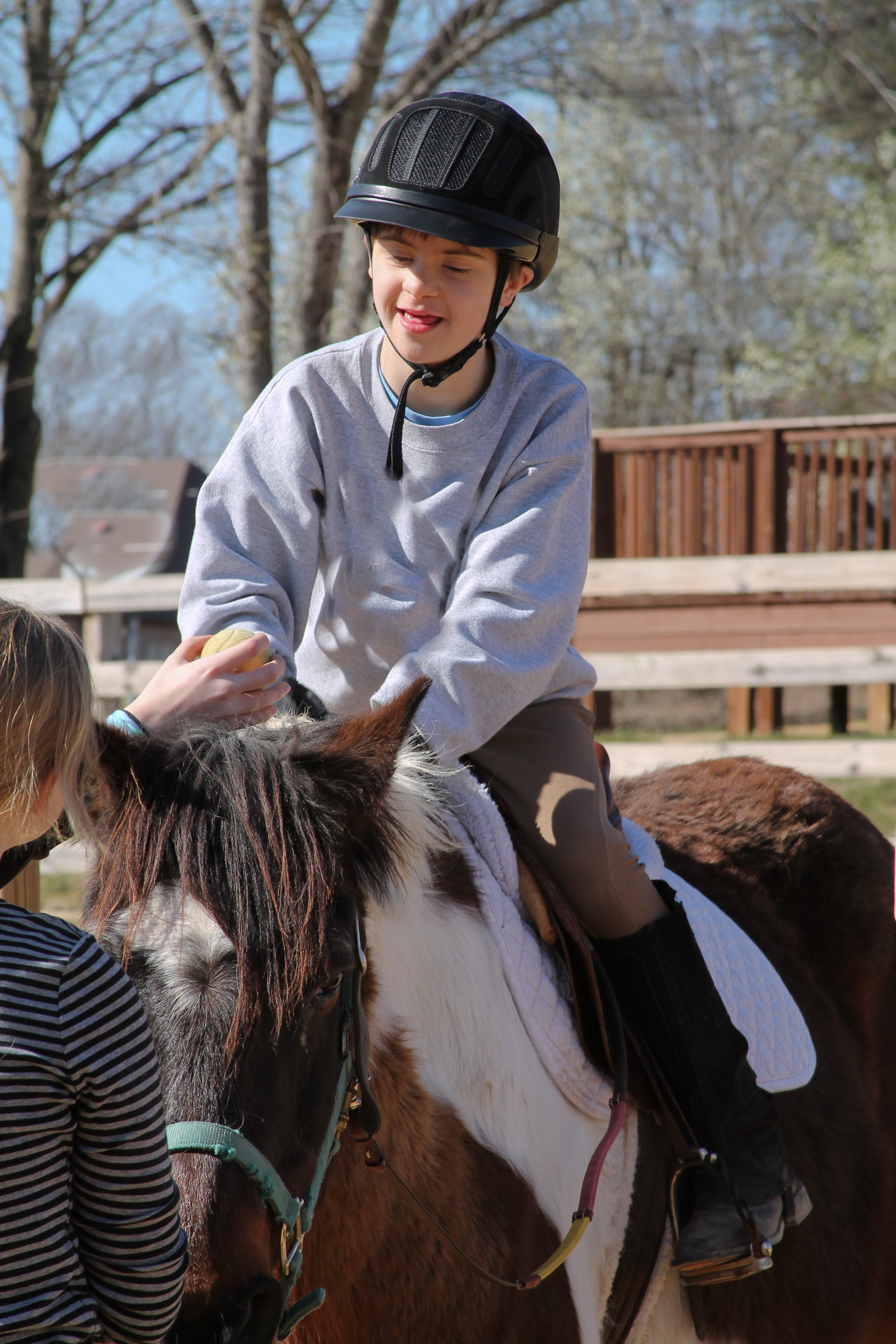 Boy riding horse for hippotherapy