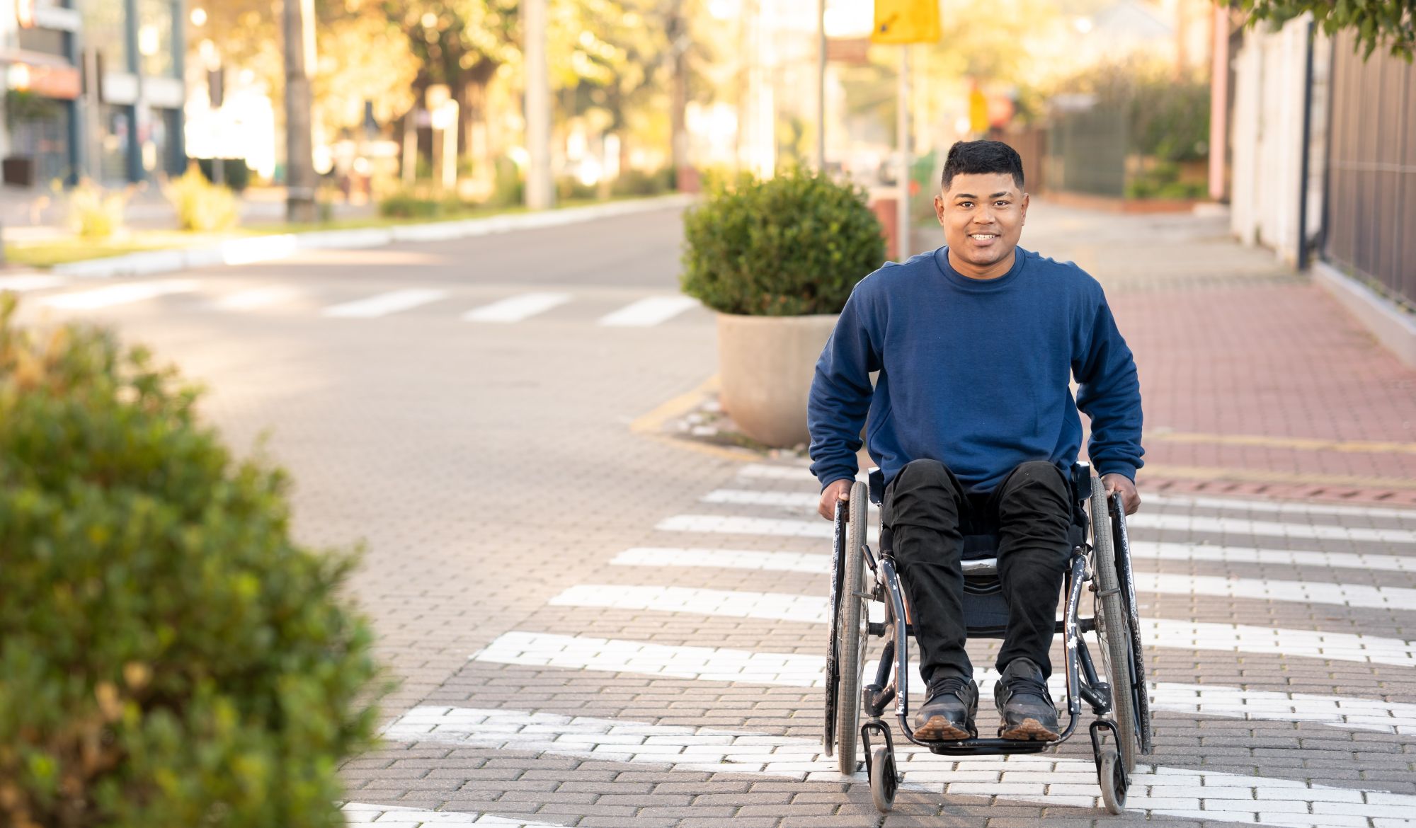 Man in wheelchair crossing the street