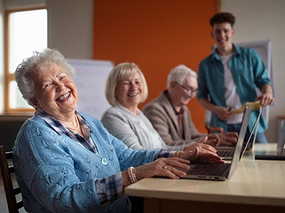 Three seniors taking a computer class