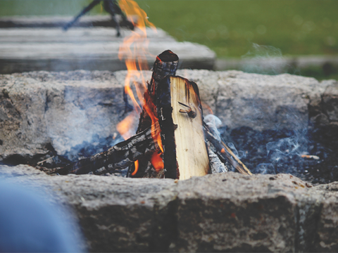campfire wood smoldering in a fire pit
