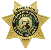 Star-shaped sheriff's badge that reads "Sheriff - Sheriff's Office Clark County" in a circle in the center. In the very center is a facsimile of the Washington state seal which features a portrait of George Washington. Text at the bottom of the star reads "1849".